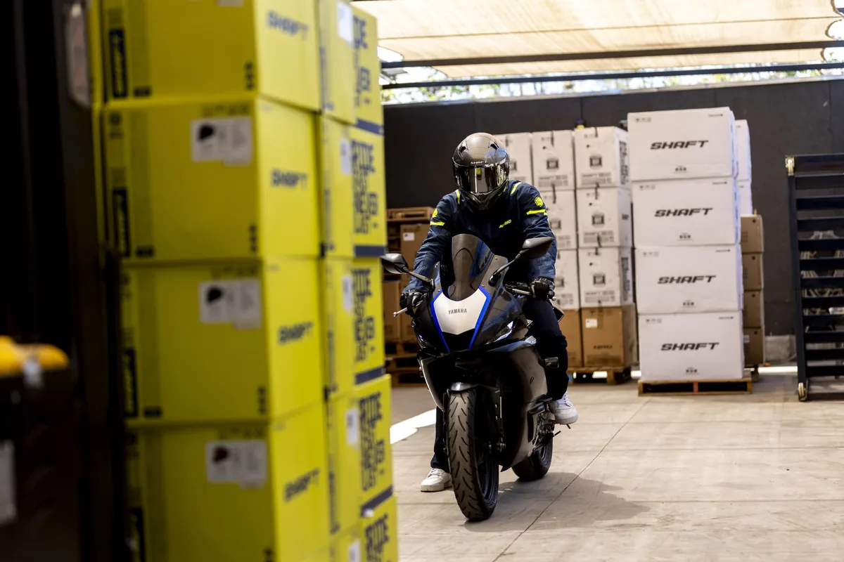 Motociclista rodando junto a estanterías de bodega